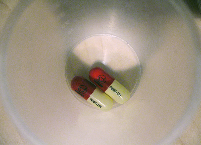 some pills in a little cup